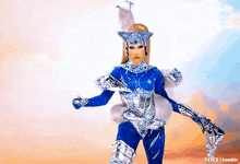 a woman in a blue and silver costume with a t4yce tumblr watermark