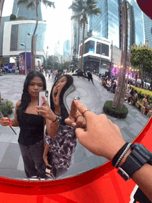 a woman taking a picture of herself with her phone