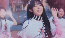 a girl with a flower in her hair is dancing