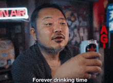 a man with a beard holds a can of beer and says " forever drinking time "