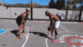 two men are playing basketball on a court that says buckets on it