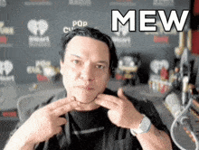 a man is making a funny face with the word mew written above him