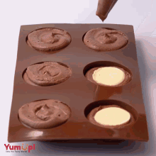 a tray of chocolate cupcakes with the words yum up written on the bottom