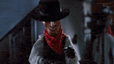 a man in a cowboy hat is pointing his finger at the camera with a subtle fx watermark in the corner