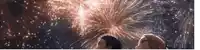 a man and a woman looking up at fireworks