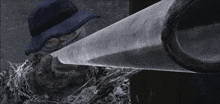 a man wearing a hat and a mask is holding a pipe
