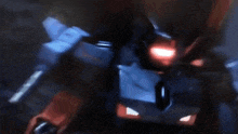 a close up of a robot with a red light on it 's face .