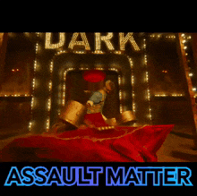 a man standing in front of a sign that says dark assault matter