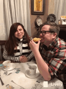 a man and a woman are sitting at a table with a sign that says happy birthday in the background