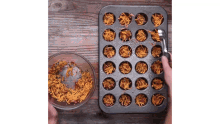 a muffin tin filled with noodles and a bowl of noodles next to it .