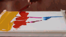 a person is painting a picture on a canvas with a knife .
