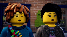 two lego figures are standing next to each other and one has a m on his shoulder