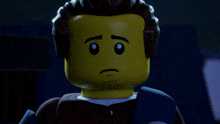a close up of a lego figure with a sad face