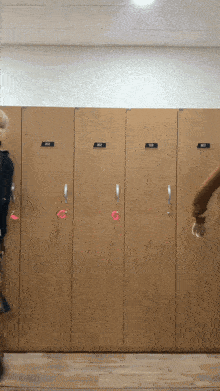 a row of wooden lockers with a sticker on the door that says ' n2 '
