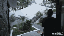 a woman is standing in a garden with the words made in animotica on the bottom right