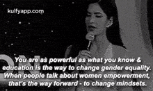 a black and white photo of a woman holding a microphone with a quote .