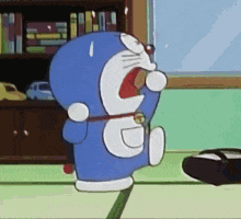 doraemon is a cartoon character that is standing on the floor eating a cookie .