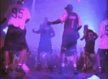 a man wearing a number 95 shirt is dancing with another man