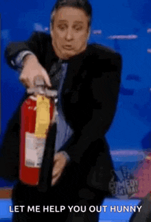 Jon Stewart Extinguish GIF - Jon Stewart Extinguish Fire Extinguisher GIFs