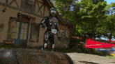 a man in a superhero costume is standing on a barrel in front of a building