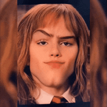 a close up of a woman 's face with a tie