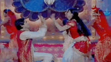 a man and a woman are dancing in front of a clock .