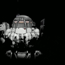 a black and white robot with a red light on the front
