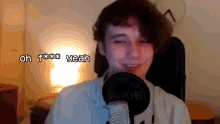 a man in front of a rode microphone says oh f*** yeah