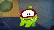a green cartoon character wearing a red cape