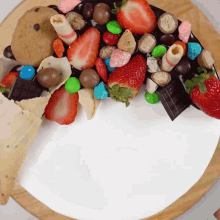 a cake with strawberries and candy on it
