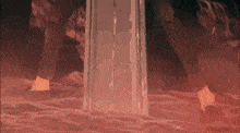a person is standing in a dark room with a door that is open