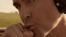 a close up of a man 's face with a dad ring on his finger