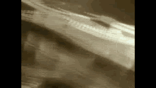 a sepia toned photo of a person 's face with a blurred background