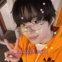a young man wearing glasses and a yellow jacket with the name keiju de anto written on it