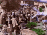 a crowd of people are gathered around a statue of a unicorn .
