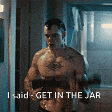 a shirtless man holding a gun with the words i said get in the jar behind him
