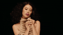 a woman in a fur coat with a pink swirl around her neck