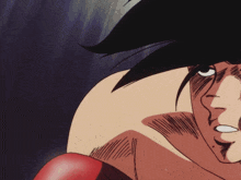 a close up of a boxer 's face with a red glove