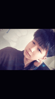 a young man taking a selfie with a phone in his hand