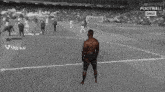 a black and white photo of a man on a football field with the name jurgeklopp on the bottom
