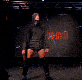 a person is kneeling in front of a large screen that says lykos gym