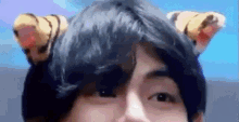 a close up of a person wearing a hat with tiger ears on their head .