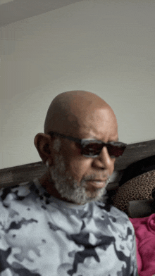 a bald man with a beard wearing sunglasses