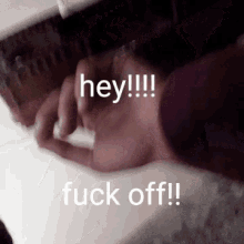 a close up of a person 's hand saying hey fuck off .