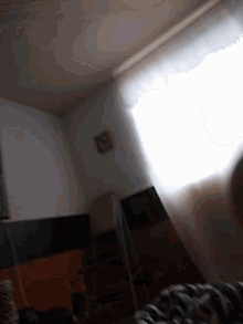 a room with a clock on the wall and a light shining through the window
