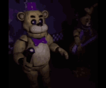 a couple of stuffed animals are standing next to each other in the dark .
