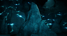 a computer generated image of a person standing on a rock in a dark cave