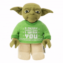 a stuffed yoda wearing a green sweater that says " a merry christmas i wish you "