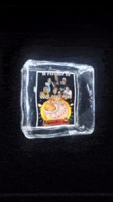 an ice cube with a picture of a group of people and a clock inside of it