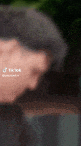 a close up of a person 's face with a tik tok watermark